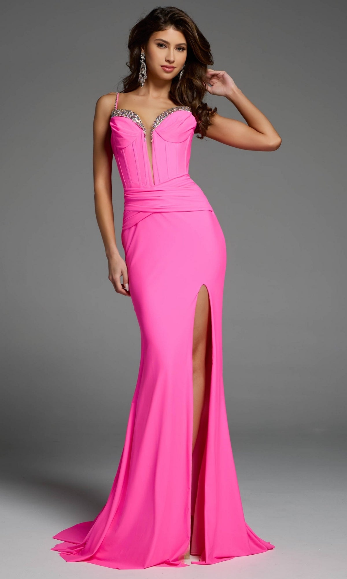 A hot pink Jovani 5020 corset prom dress with a sweetheart neckline, rhinestone detailing, a cinched waist, and a high leg slit.